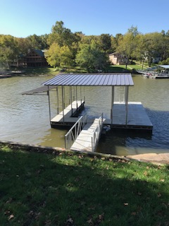 Far view of a small rectangular dock with a roof