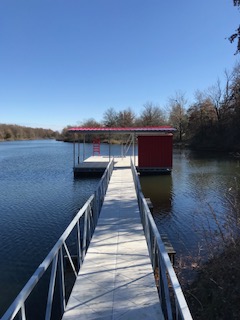 A dock with a red shed