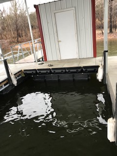 A dock with a small white shed